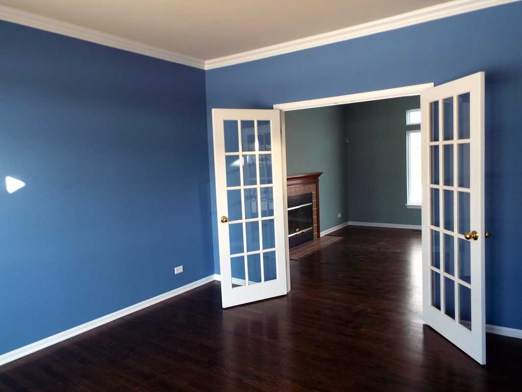 D.F. Painting picture of a blue family room with white trim and doors leading into their living room 