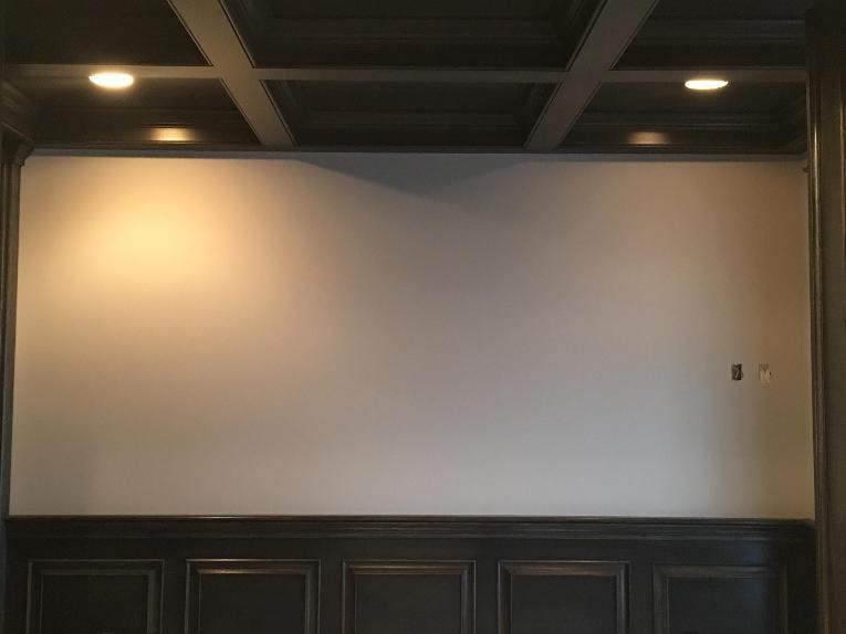 A picture of a wall in an office D.F. Painting painted. All of the wainscoting and wood is stained. 